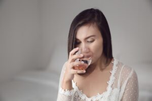 A woman drinking water before bedtime